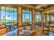 Refined dining area with large windows, scenic views, and elegantly set tables, offering a luxurious experience at 10580 Riva Grande Ct, Las Vegas, NV 89135