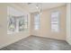 Dining area with plank flooring, natural light and modern lighting fixture at 10580 Riva Grande Ct, Las Vegas, NV 89135
