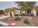 Well-maintained home featuring desert landscaping and a two-car garage at 10580 Riva Grande Ct, Las Vegas, NV 89135
