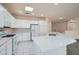Bright kitchen featuring white cabinets, stone countertops, and stainless steel appliances at 10580 Riva Grande Ct, Las Vegas, NV 89135
