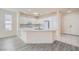 Well-lit kitchen with white cabinetry, stainless appliances, and breakfast bar seating at 10580 Riva Grande Ct, Las Vegas, NV 89135