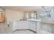 Kitchen featuring white cabinets, granite countertops, stainless appliances, and a breakfast bar at 10580 Riva Grande Ct, Las Vegas, NV 89135