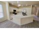 Bright kitchen features white cabinetry, a large island, and stainless steel appliances, perfect for cooking and entertaining at 10580 Riva Grande Ct, Las Vegas, NV 89135