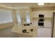 Modern kitchen with white cabinets, stainless appliances, and large island with seating at 10580 Riva Grande Ct, Las Vegas, NV 89135