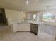 Well-lit kitchen featuring a spacious island, ample counter space, and modern appliances, ideal for culinary enthusiasts at 10580 Riva Grande Ct, Las Vegas, NV 89135