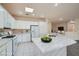Bright kitchen featuring white cabinetry, granite countertops, and stainless steel appliances at 10580 Riva Grande Ct, Las Vegas, NV 89135