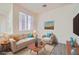 Bright living room with large window, modern furniture, and stylish décor at 10580 Riva Grande Ct, Las Vegas, NV 89135
