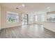 Open floor plan living area with sliding glass doors to the backyard and kitchen view at 10580 Riva Grande Ct, Las Vegas, NV 89135