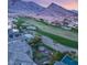 Beautiful aerial shot revealing the property's backyard oasis, golf course access, and stunning mountain backdrop at 11680 Evergreen Creek Ln, Las Vegas, NV 89135