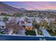 Breathtaking aerial view showcasing the property's prime location with mountain views and a lush golf course at 11680 Evergreen Creek Ln, Las Vegas, NV 89135