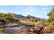 Inviting backyard patio with a fire pit, comfortable seating, and serene golf course views at 11680 Evergreen Creek Ln, Las Vegas, NV 89135