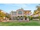 Expansive backyard featuring lush grass, elegant statues, and a beautiful multi-story home at 11680 Evergreen Creek Ln, Las Vegas, NV 89135