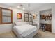 Bright bedroom featuring a queen-sized bed, custom window shutters, and a built-in desk with shelving at 11680 Evergreen Creek Ln, Las Vegas, NV 89135