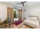 Bright bedroom with a courtyard view, featuring an ornate writing desk and access to outdoor space at 11680 Evergreen Creek Ln, Las Vegas, NV 89135