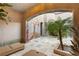 Tranquil courtyard featuring unique wall art, potted plants, tiled flooring, and comfortable lounge seating at 11680 Evergreen Creek Ln, Las Vegas, NV 89135
