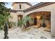 Charming courtyard with tiled flooring, lush greenery, comfortable lounge chairs, and unique architectural details at 11680 Evergreen Creek Ln, Las Vegas, NV 89135