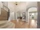 Grand foyer with arched doorways, soaring ceilings, and hardwood floors, offering a bright, open feel at 11680 Evergreen Creek Ln, Las Vegas, NV 89135