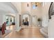 Spacious foyer featuring hardwood floors, high ceilings, and multiple arched entryways, enhancing the open layout at 11680 Evergreen Creek Ln, Las Vegas, NV 89135