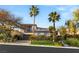 Charming two-story home with a well-manicured lawn, mature palm trees, and a classic garage door at 11680 Evergreen Creek Ln, Las Vegas, NV 89135