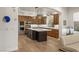 Open concept kitchen features a center island, stainless steel appliances, and wood floors at 11680 Evergreen Creek Ln, Las Vegas, NV 89135