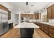 Gourmet kitchen boasts a center island, stainless steel appliances, and custom wood cabinetry at 11680 Evergreen Creek Ln, Las Vegas, NV 89135