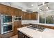Gourmet kitchen with stainless steel appliances, marble countertops, and custom wood cabinetry at 11680 Evergreen Creek Ln, Las Vegas, NV 89135