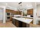 Bright kitchen features a large island with white countertop, custom cabinets, and hardwood floors at 11680 Evergreen Creek Ln, Las Vegas, NV 89135