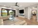 Bright living room with hardwood floors, stylish decor, and a view of the outdoor landscape at 11680 Evergreen Creek Ln, Las Vegas, NV 89135