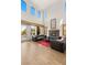 Bright living room with high ceilings, a modern fireplace, and expansive windows providing ample natural light at 11680 Evergreen Creek Ln, Las Vegas, NV 89135