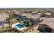 An aerial view of a backyard with a modern pool, outdoor seating, and well-maintained lawn at 11834 Albissola Ave, Las Vegas, NV 89138