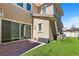 Backyard with artificial turf and patio featuring sliding glass doors to the home's interior at 11834 Albissola Ave, Las Vegas, NV 89138