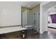 Well-lit bathroom with standalone shower and tub, light tile accents, and white shutters on the window at 11834 Albissola Ave, Las Vegas, NV 89138