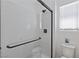 Bathroom features seamless glass shower, with black hardware and white quartz countertops at 11834 Albissola Ave, Las Vegas, NV 89138