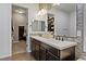 Bathroom with double sink vanity, large mirror, and walk-in closet access at 11834 Albissola Ave, Las Vegas, NV 89138