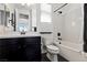 Well lit bathroom features black hardware and white quartz countertops and shower/tub combo at 11834 Albissola Ave, Las Vegas, NV 89138