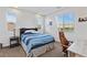 Inviting bedroom with two windows and comfortable bed features a work desk at 11834 Albissola Ave, Las Vegas, NV 89138