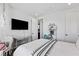 Bedroom features a swing chair, desk, neutral colors, and natural light at 11834 Albissola Ave, Las Vegas, NV 89138
