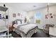 Bedroom features natural light, neutral walls, carpeted floor and curated decor at 11834 Albissola Ave, Las Vegas, NV 89138