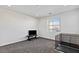 Bright bonus room with neutral walls and carpet features a window with blinds and cage at 11834 Albissola Ave, Las Vegas, NV 89138