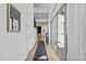 Hallway featuring wood floors, tall ceilings, access to patio, and a stairway at 11834 Albissola Ave, Las Vegas, NV 89138