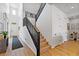 Bright hallway with wood floors, white walls, black stair railing, and plenty of natural light at 11834 Albissola Ave, Las Vegas, NV 89138
