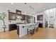 Modern kitchen with dark wood cabinets, stainless steel appliances, and a large center island at 11834 Albissola Ave, Las Vegas, NV 89138