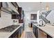 Gourmet kitchen featuring stainless steel appliances, island with sink, and dark wood cabinetry at 11834 Albissola Ave, Las Vegas, NV 89138