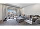 Relaxing living room with sliding glass doors to a patio and comfortable grey sectional at 11834 Albissola Ave, Las Vegas, NV 89138