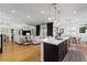 Open-concept living space with kitchen island, dining area, and living room, perfect for entertaining at 11834 Albissola Ave, Las Vegas, NV 89138
