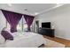 Main bedroom with French doors to backyard, wood floors, neutral walls, and thick decorative drapes at 11834 Albissola Ave, Las Vegas, NV 89138
