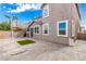 Backyard with textured concrete, artificial turf, and a second-story deck with outdoor staircase at 140 Rolling Cove Ave, Henderson, NV 89011