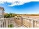 View of the open land from the wooden balcony with matching railing at 140 Rolling Cove Ave, Henderson, NV 89011