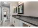 Bathroom featuring granite countertop, framed mirror, and views into the open-plan shower at 140 Rolling Cove Ave, Henderson, NV 89011