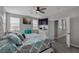 Comfortable bedroom with plush bedding, ceiling fan, and natural light from large windows at 140 Rolling Cove Ave, Henderson, NV 89011